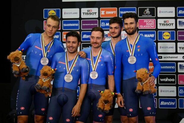 Simone Consonni (C) with team pursuit teammates on the podium in Glasgow