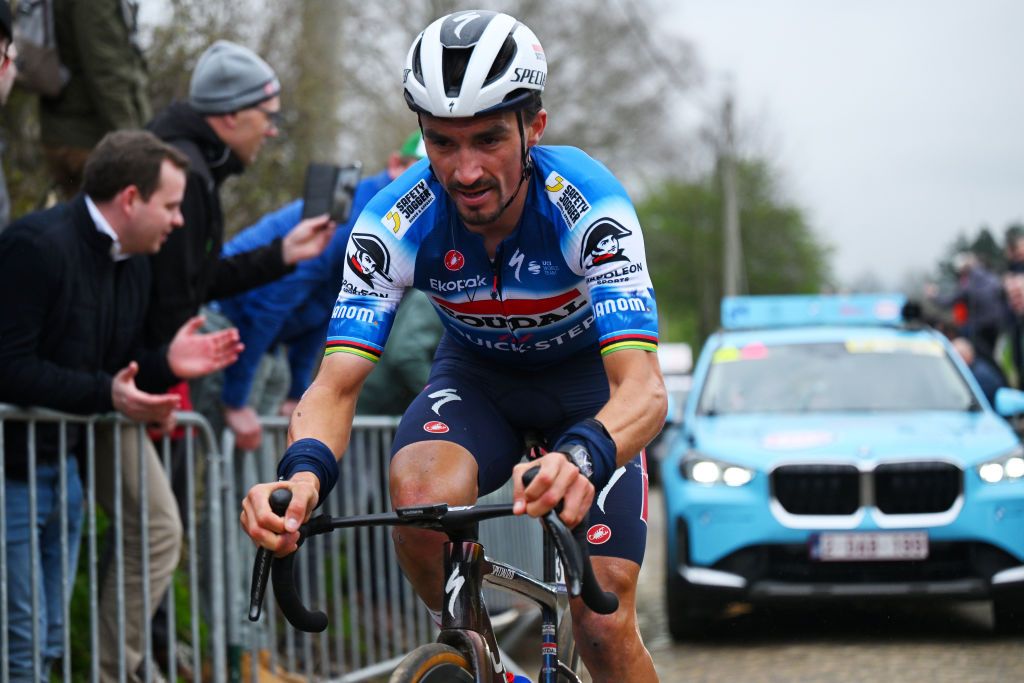 HARELBEKE BELGIUM MARCH 22 Julian Alaphilippe of France and Team Soudal QuickStep competes passing through the Oude Kwaremont cobblestones sector while fans cheer during the 67th E3 Saxo Bank Classic Harelbeke 2024 a 2076km one day race from Harelbeke to Harelbeke UCIWT on March 22 2024 in Harelbeke Belgium Photo by Tim de WaeleGetty Images