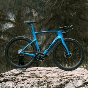 A blue Pinarello Dogma F stands on a rock