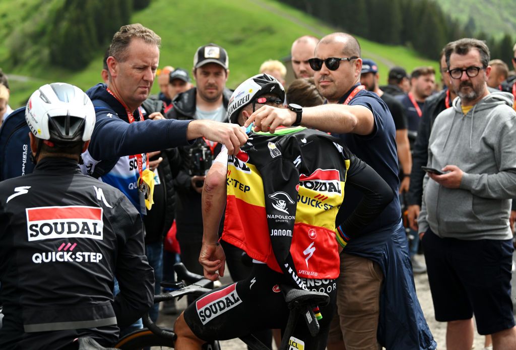 Critérium du Dauphiné stage 7: Remco Evenepoel gets warm clothes from team support staff after the finish