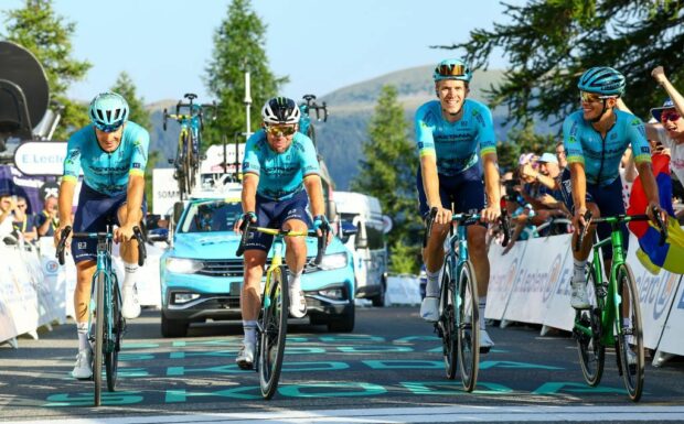 Mark Cavendish crosses the line on stage 20 of the Tour de France alongside his Astana Qazaqstan teammates