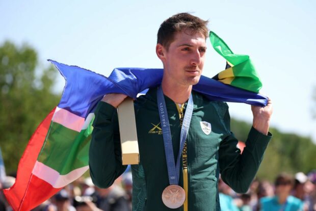 Bronze medallist Alan Hatherly of Team South Africa poses on the podium with his flag during the men