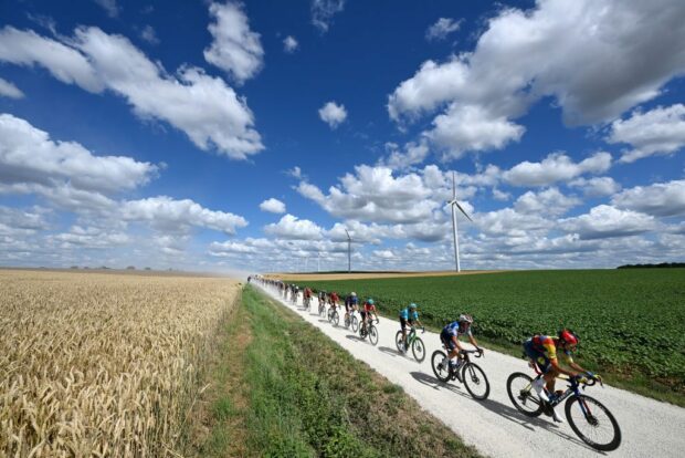 Peloton negotiating the thick gravel roads on stage 9 at the Tour de France