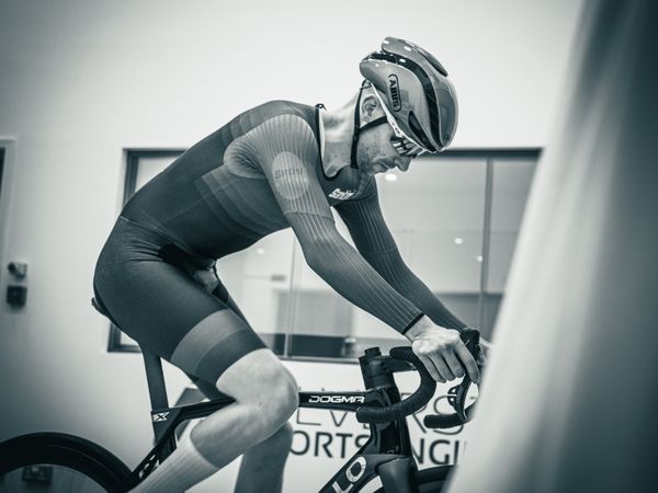 A man riding a Pinarello bike in the wind tunnel