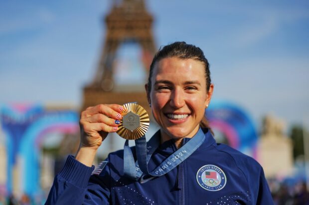 Kristen Faulkner (USA) celebrates with her Olympic Gold Medal after winning the Women