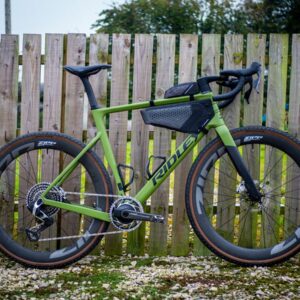 Detail photo of a green Ridley ASTR RS leaning against a wooden fence