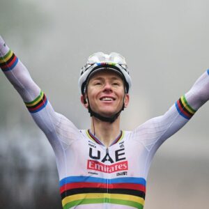 Tadej Pogacar celebrates winning in the rainbow jersey