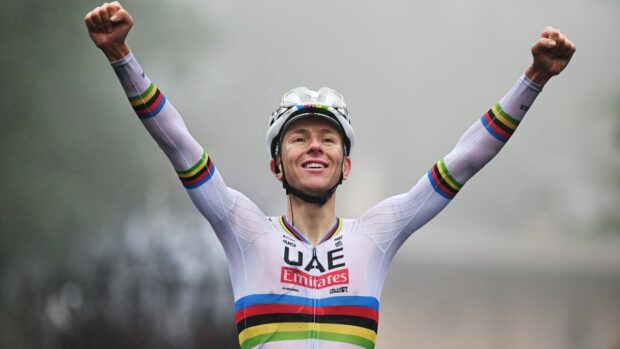 Tadej Pogacar celebrates winning in the rainbow jersey