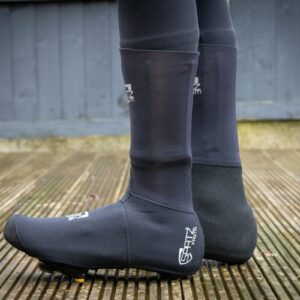 The Spatz Fasta overshoe beoing worn by a rider standing on a wooden deck