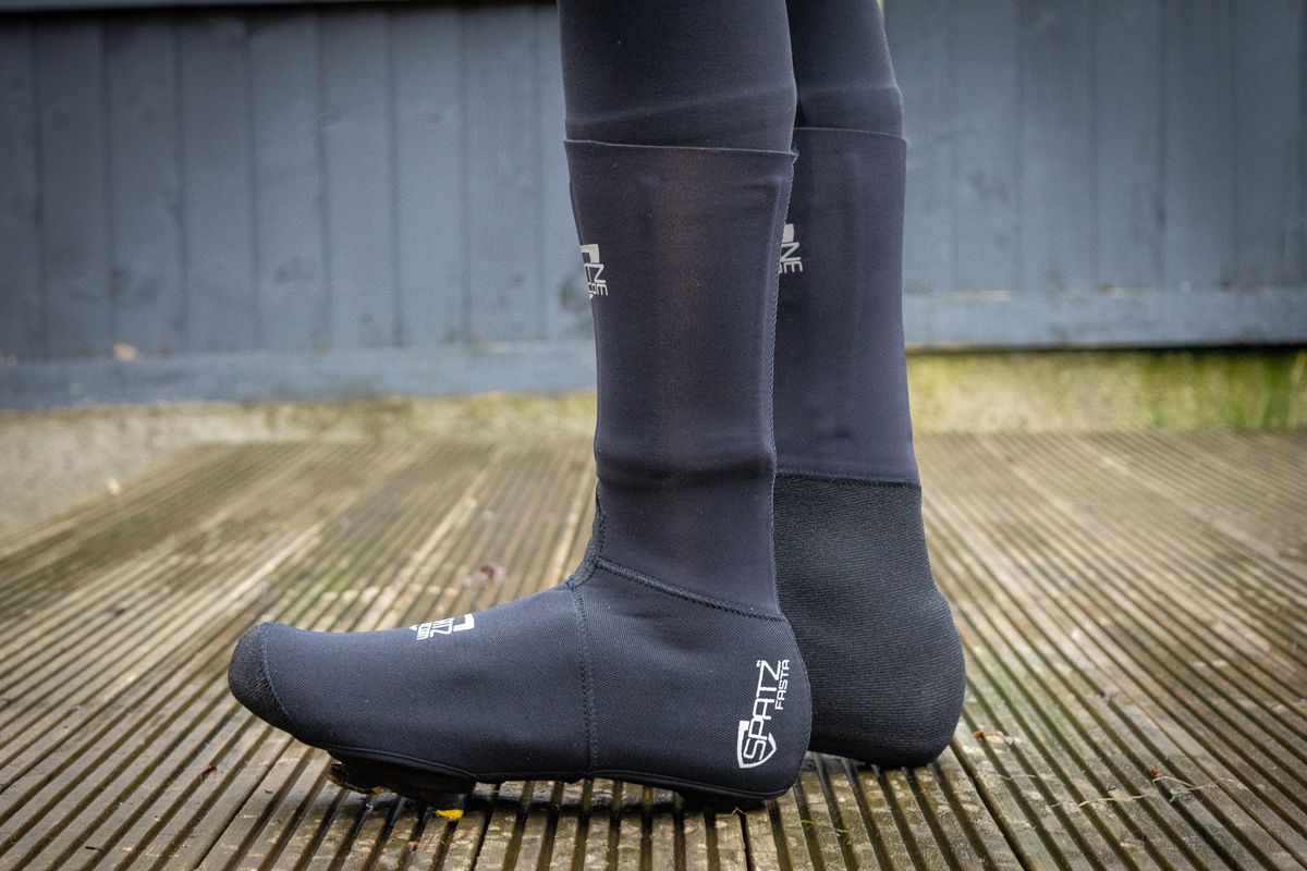 The Spatz Fasta overshoe beoing worn by a rider standing on a wooden deck