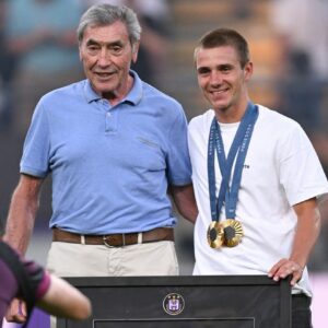 Five-time Tour de France champion and Anderlecht fan Eddy Merckx poses with 2024 Olympic double gold medal winner Remco Evenepoelat the start of a soccer match between RSC Anderlecht and OHL Oud-Heverlee - Leuven in August 2024 in Brussels