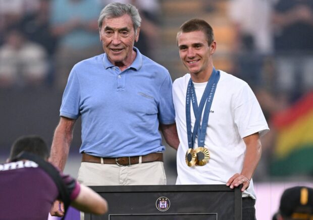 Five-time Tour de France champion and Anderlecht fan Eddy Merckx poses with 2024 Olympic double gold medal winner Remco Evenepoelat the start of a soccer match between RSC Anderlecht and OHL Oud-Heverlee - Leuven in August 2024 in Brussels