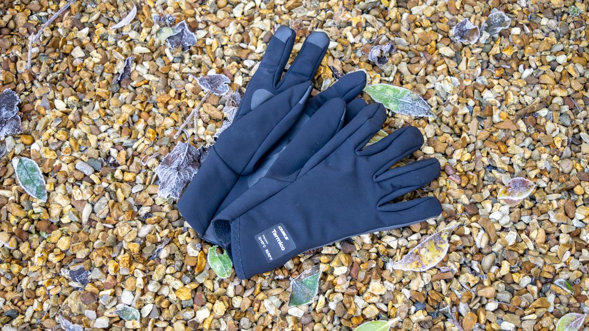 A pair of Q36.5 Termico gloves on some gravel