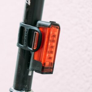 A red bike light attached to a seat post