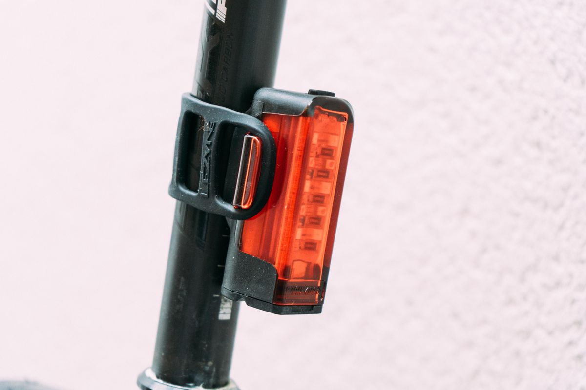 A red bike light attached to a seat post