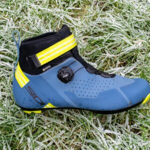 A blue Sidi Nix winter boot on frosty grass