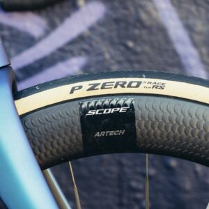 A close up of a deep black bicycle rim with a Pirelli P Zero Race TLR RS tyre mounted to it