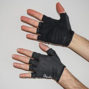 A man wearing a pair of black Rapha Core cycling mitts