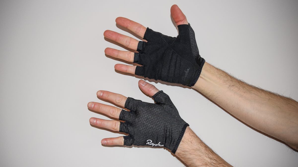 A man wearing a pair of black Rapha Core cycling mitts