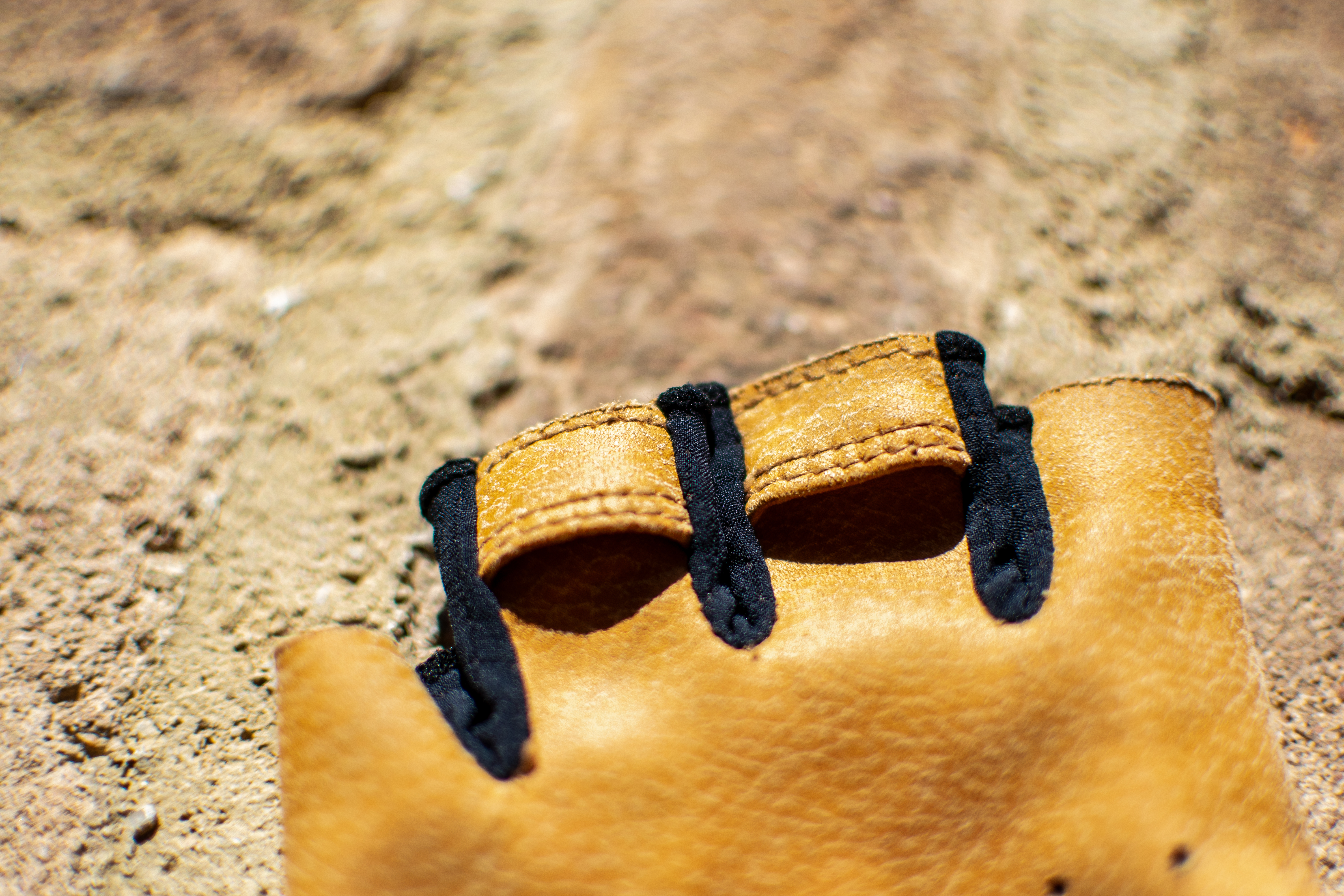 Une paire de mitaines de perles Izumi Pro sur un mur de briques